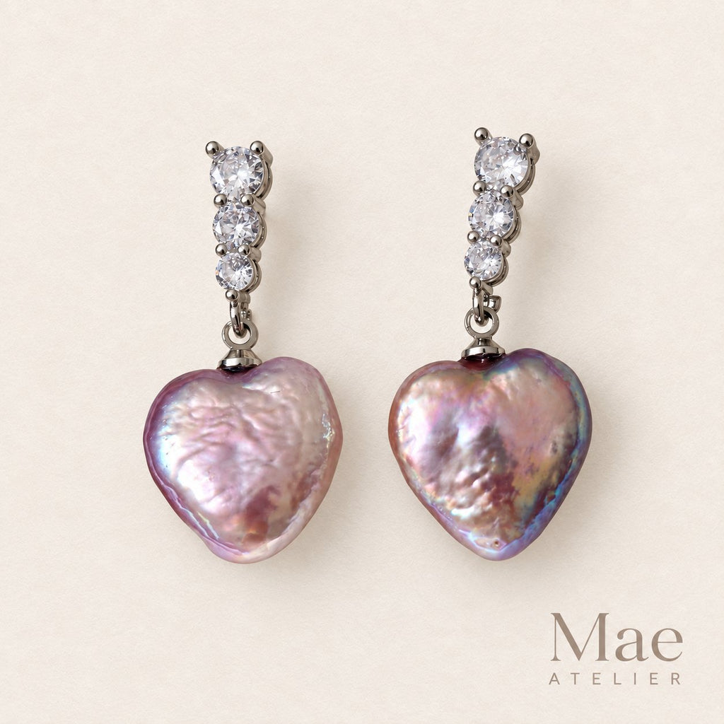 Side view of purple heart pearl drop earrings, white gold plated