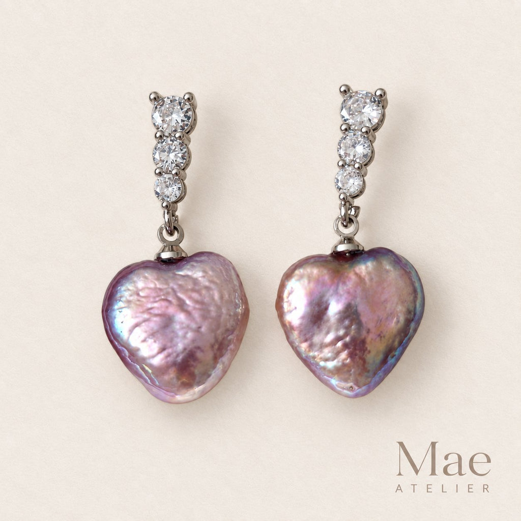 Model wearing purple heart pearl drop earrings