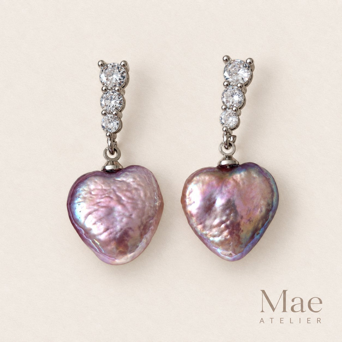 Model wearing purple heart pearl drop earrings
