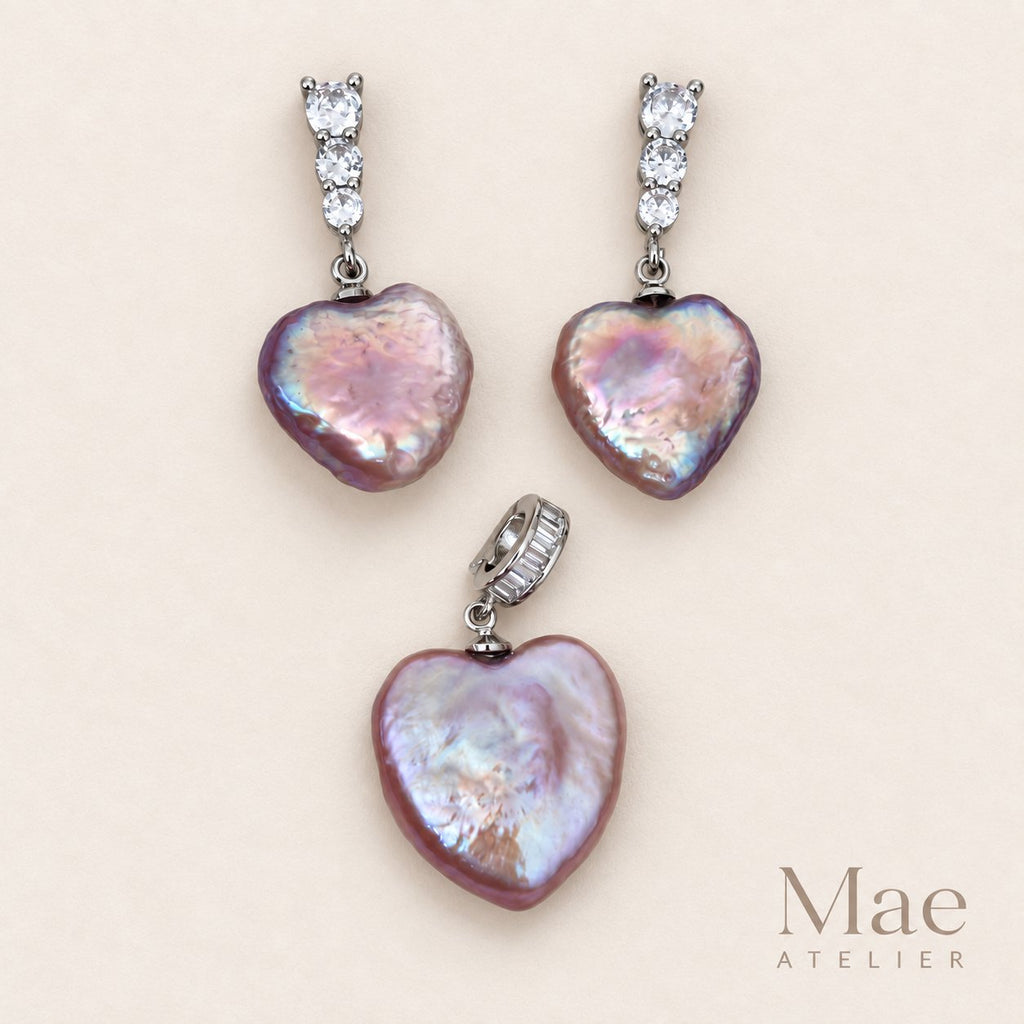 Model wearing purple heart pearl earrings and pendant set